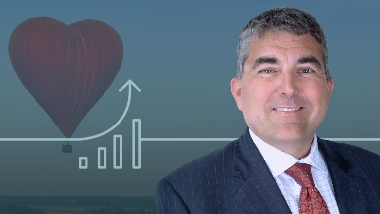 Joe Maier headshot over an ariel image of a hot air balloon.