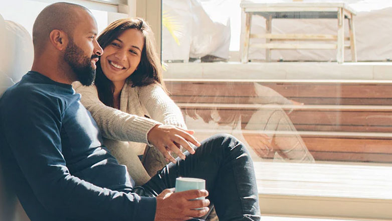 Couple sitting on kitchen floor and dreaming together.