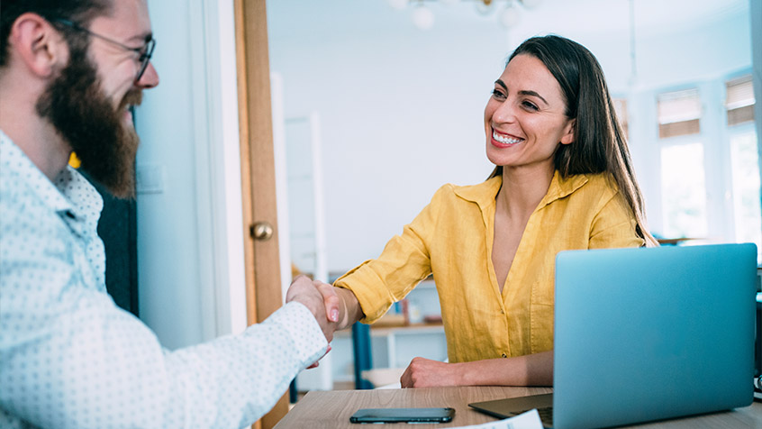 man and woman shaking hands in agreement.