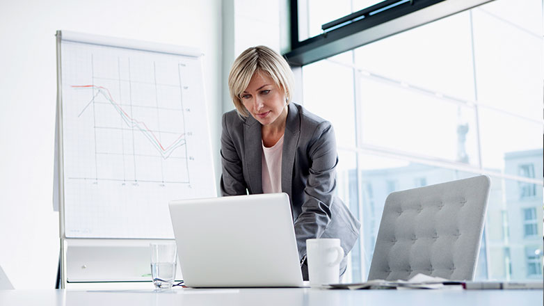 Female executive in her office working on her laptop.