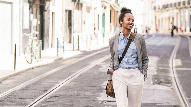 Woman traveling abroad walking along the street.