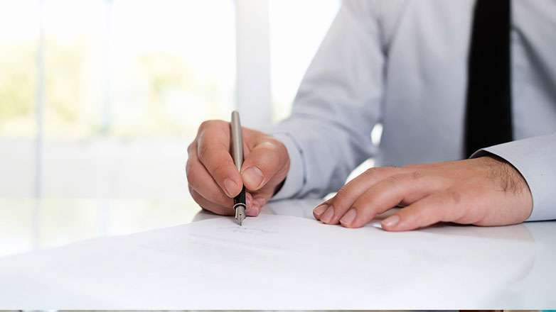 hand signing signature on official document